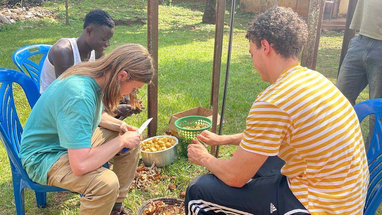 Interns learning Uganda culture of preparing food